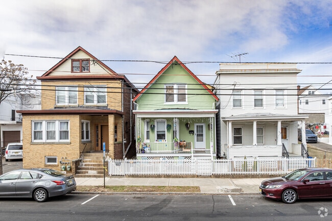 A prominent style in Hall Avenue is the narrow, two-story colonial-style home, often featuring inviting front porches that enhance the neighborhood's charm.