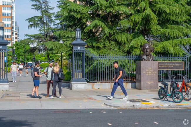 GW students walk home from classes past the bust of George Washington outside the school's gate.