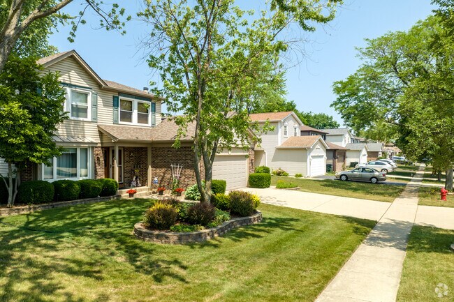 Ranch-style, split-level & Colonial Revival houses are on small suburban lots in Elk Grove.