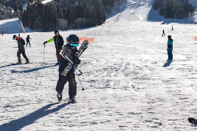 Skiers and snowboarders enjoy a day on the slopes at Snowbasin near Plain City.