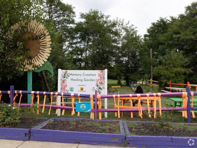 A Harlem Park resident sits in the Healing Garden.