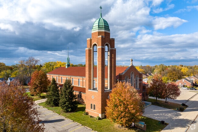 Residents of Mohican Regent pass by historic St. Raymond's Parish.