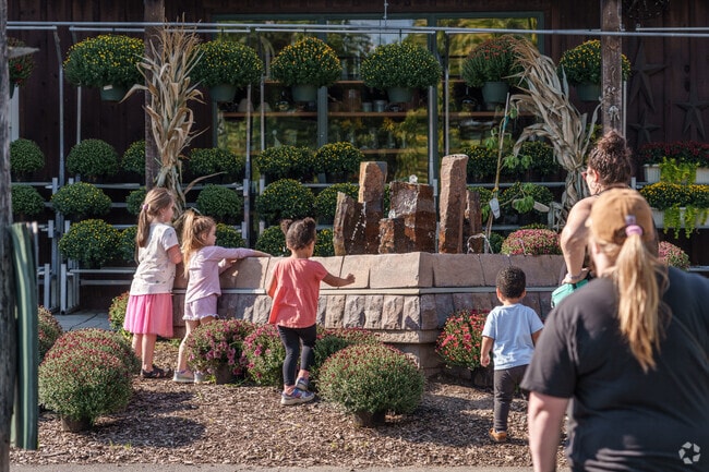 Kids run to play at the small fountain at Linvilla Orchards near Chester Township.