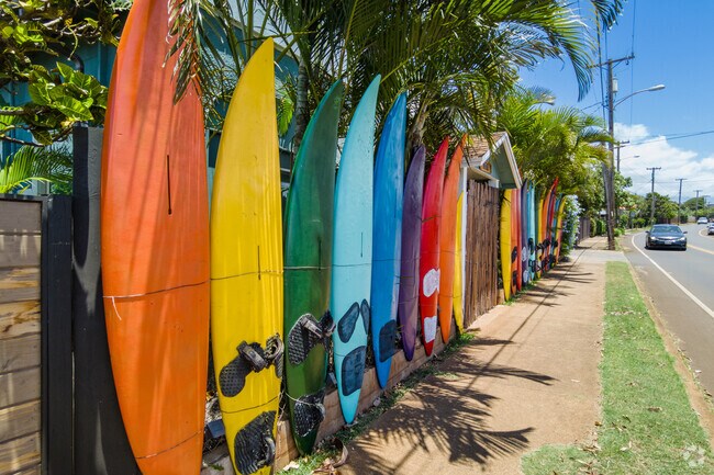Colorful surfboards line the sidewalk at Aloha Surf Hostel.