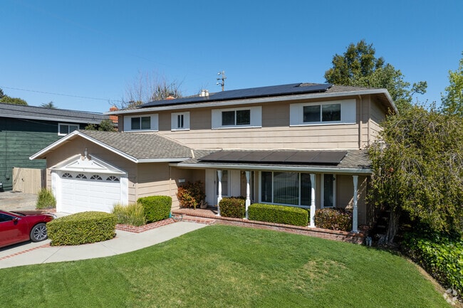 Traditional Two-Story Suburban Colonial home in Montevideo with brick trim and a covered porch.
