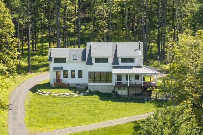 A contemporary style home is nestled in the woods in Kerhonkson, NY.