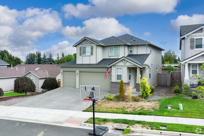 A basketball hoop sits in front of a contemporary home on SE 25th St in Mount Hood.
