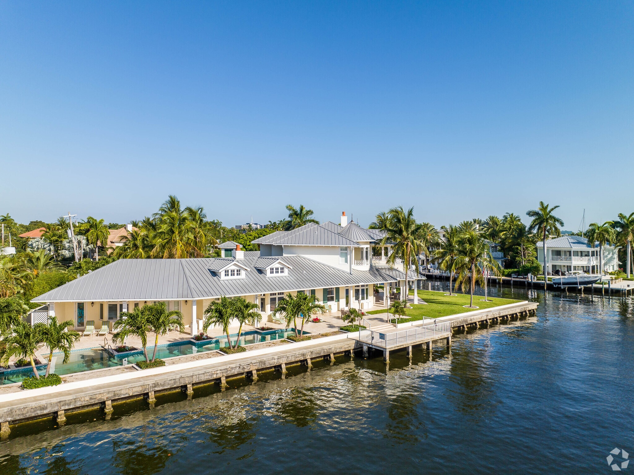 Bright waterfront homes surrounded by lush greenery in the Dolphin Isles neighborhood.