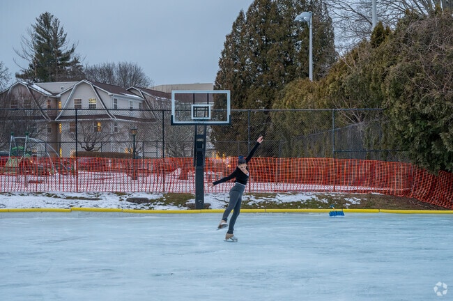 A resident figure skates in a basketball court converted into an ice-rink in Briarcliff Manor.
