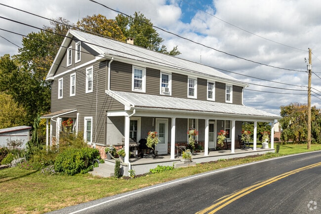 This large colonial revival home features a mostly-wooded property in the middle of Millcreek.