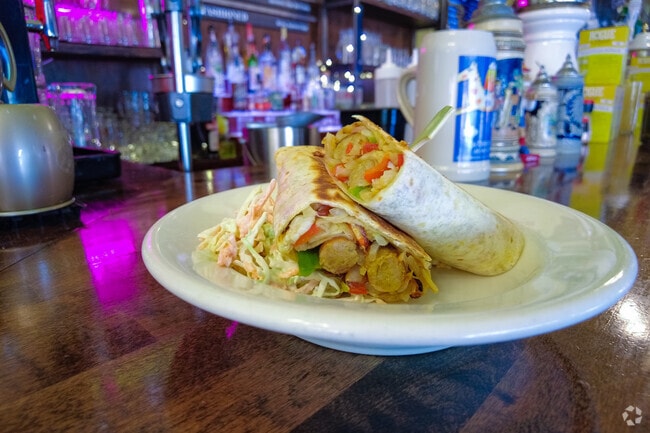 Wrapped bratwurst at the Urban German happy hour in Cathedral Park, Portland.