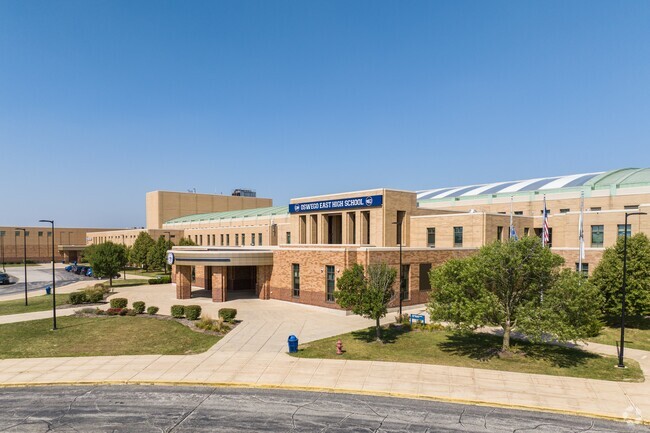 Oswego East High School featuring a distinct semi-circular roof.