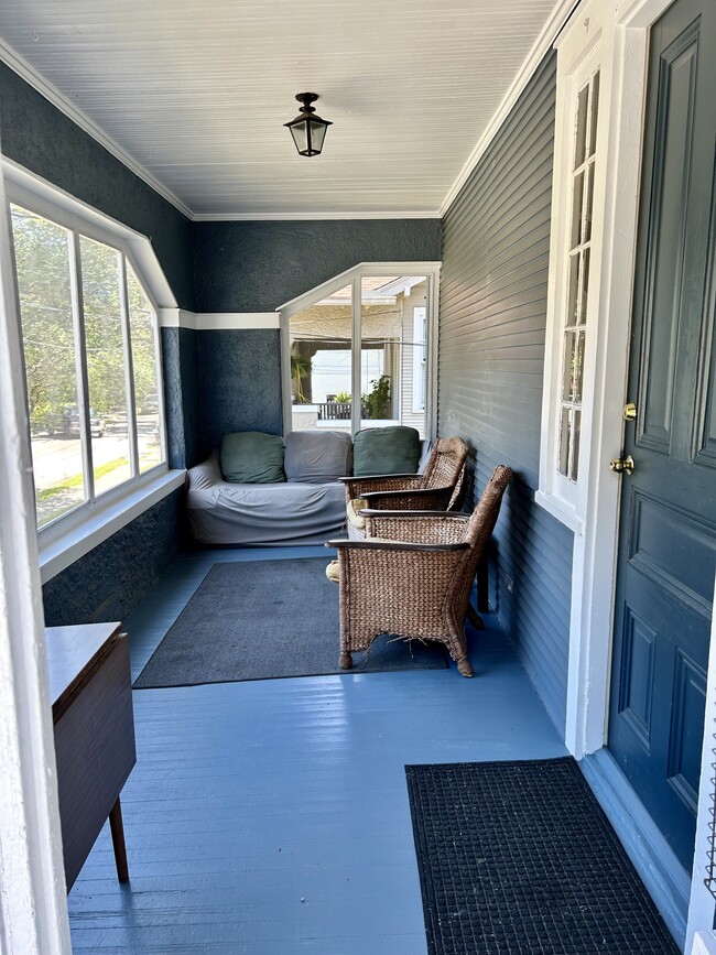 Large front porch can be redecorated to be cuter but the guys seem to like the sofas.