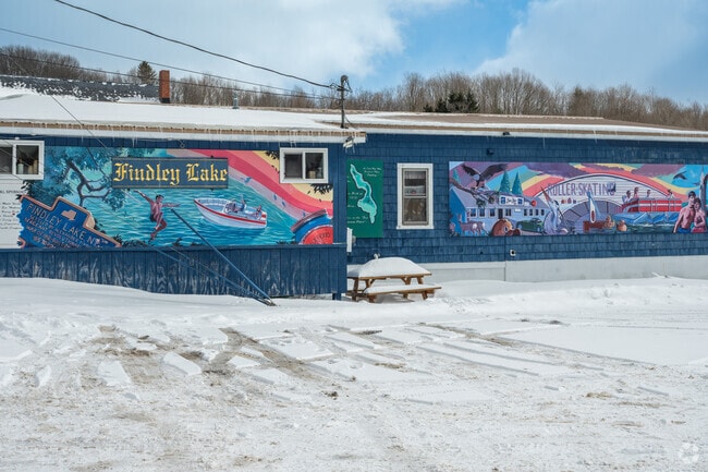 A colorful mural of Findley Lake sits on the side of Twin Docks Gourmet Food and Deli in Mina.