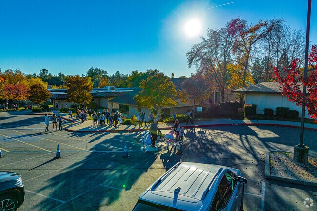 Sun sets behind St. Joseph Catholic School as children wait pickup.
