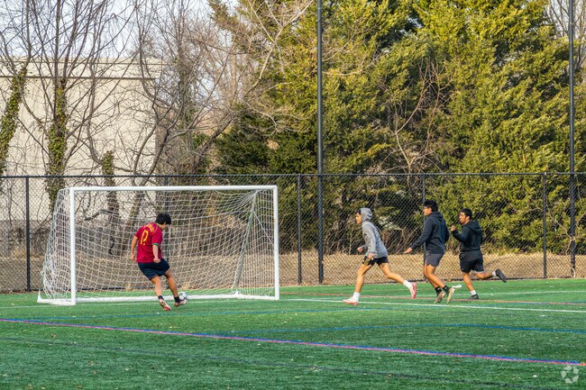 Friends gather on the soccer fields at Chapel Ave Park for pick up games.