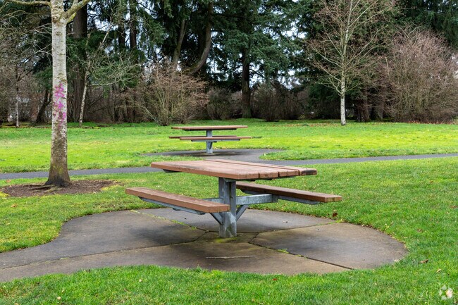 Picnic tables sit next to the playground area.