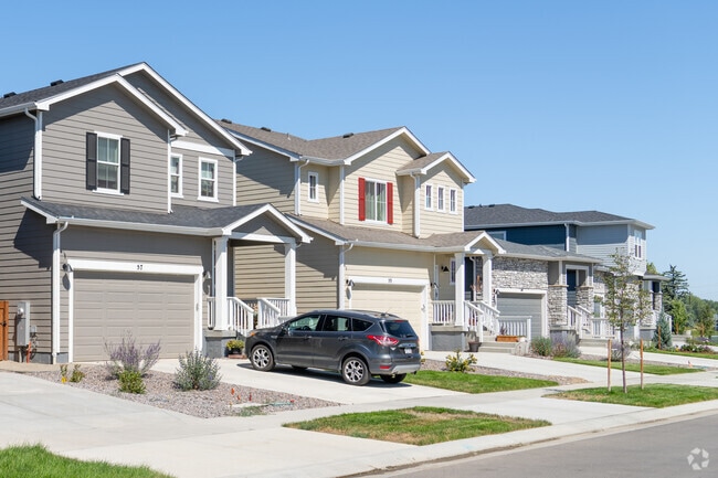 West Saint Vrain homes with uniform facades, tidy lawns, and inviting front porches.