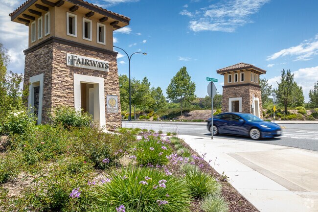 Flowers seen next to neighborhood signage in Fairway Canyon neighborhood.