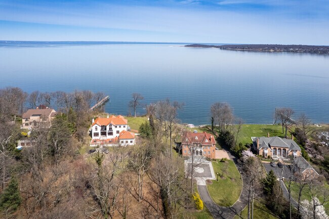 A beautiful row of mansions overlook Lloyd Harbor with Connecticut in the distance.