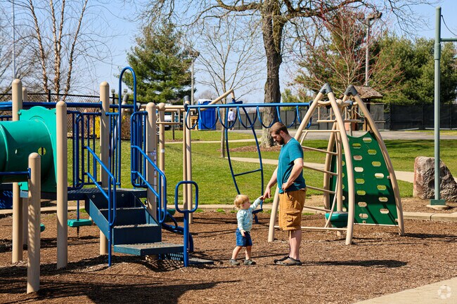 A father and son play on the swings at Mill Creek Wick recreation area in Schenley.