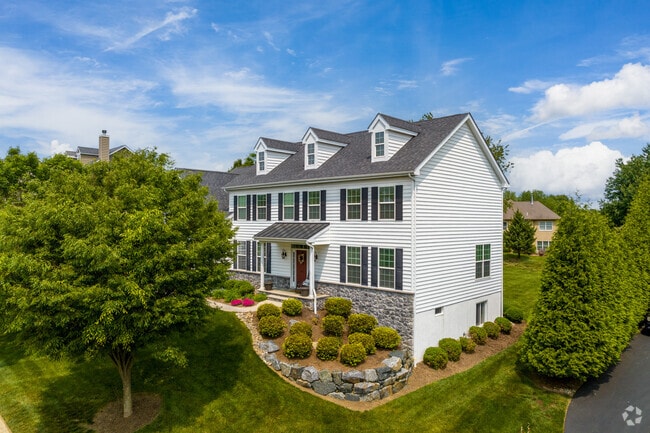A white Cape Cod style home rests on a hill in Hockessin.
