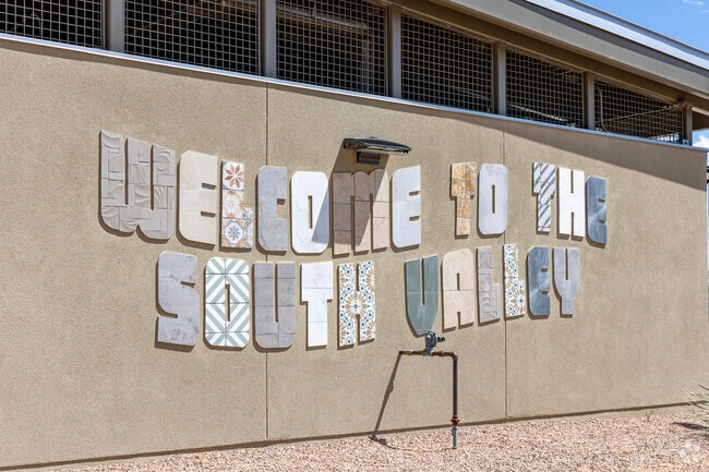 Signage on the South Valley Public Library welcomes all to Adobe Acres.