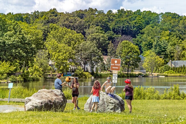 Families in Netcong gather by Lake Musconetcong for simple joys climbing rocks, sharing laughs, and soaking in the fresh air of a vibrant community park.