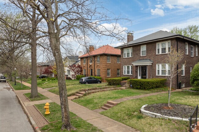 Side-by-side sit brick masterpiece homes along tree-lined streets.