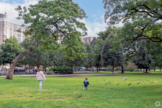 Neighbors utilizes the green space at Joyce Kilmer Park