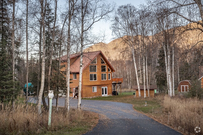 Three-level log cabin homes with picture windows offer stunning vistas of South Fork.
