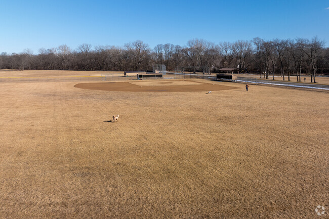 Kelley Myers Park includes a playground, picnic tables, a sports field, swings, and a creek.