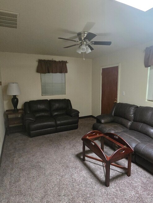 LIVING ROOM....WALL TO WALL CARPET...LEATHER RECLINING COUCH AND LOVESEAT....SKYLIGHT!!!