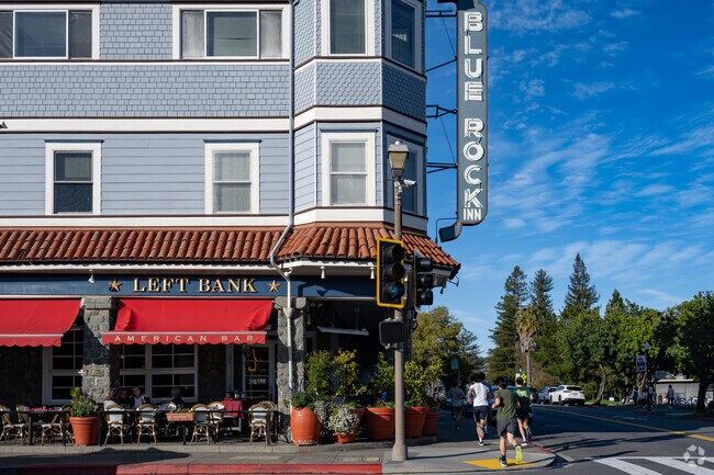 South Magnolia youth jog past the Blue Rock building where many locals enjoy a meal at the Left Bank.