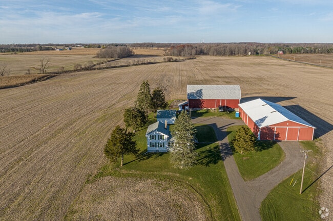 Classic farmhouses are built on the vast farmlands of the Dimondale neighborhood.