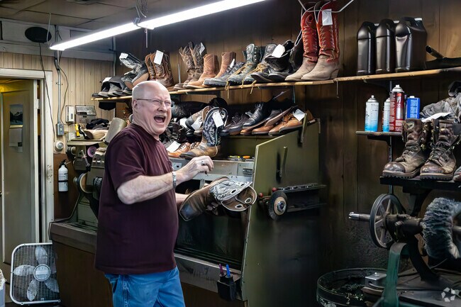 Ray of the shoe repair shop Ray’s works with a smile in Kaysville.