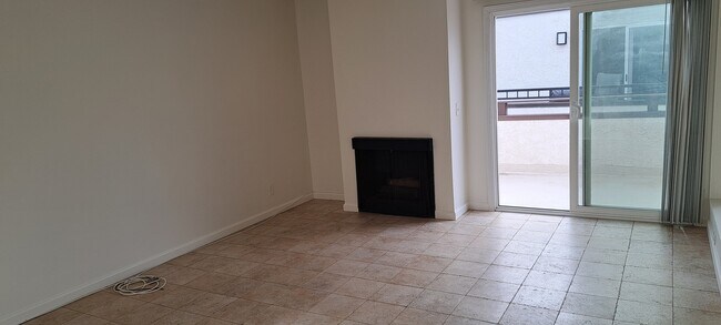 LIVING ROOM WITH FIREPLACE AND SLIDER TO BALCONY, TRAVERTINE STYLE PORCELAIN TILES