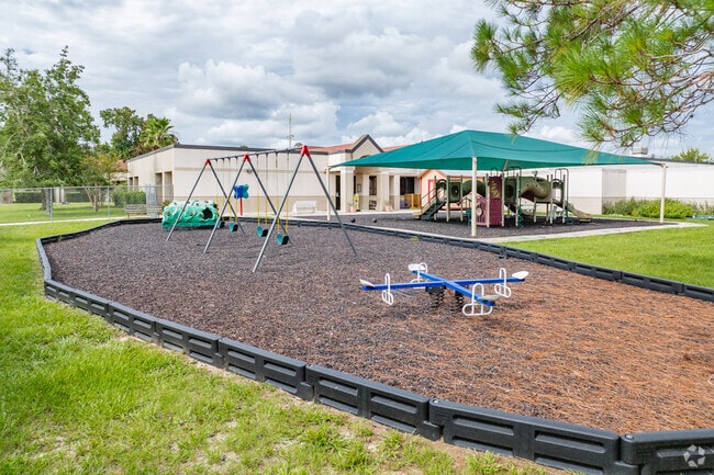 Kids enjoy playing on the play area at Saint John Paul II Catholic School.