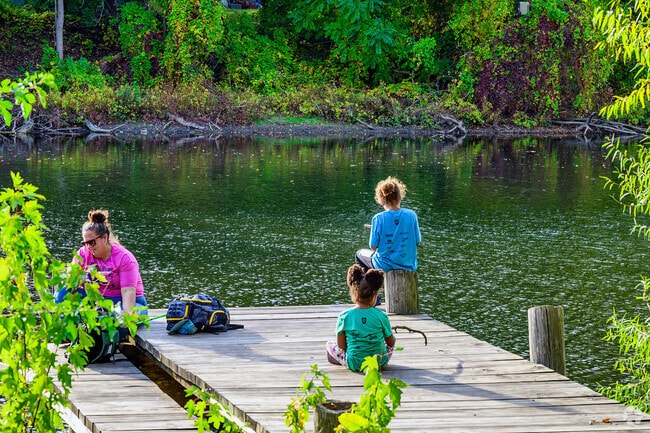 A family spends a summer afternoon fishing along the Grand River near Knollwood Willow.
