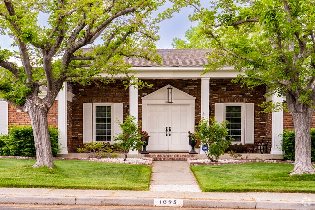Gorgeous white pillars support a covered porch in this Hunter Lake residence.