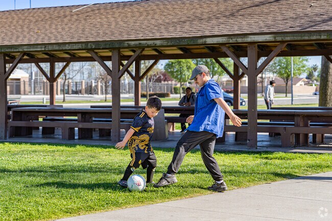 A Wasco father enjoys playing soccer with his son at Westside Park.
