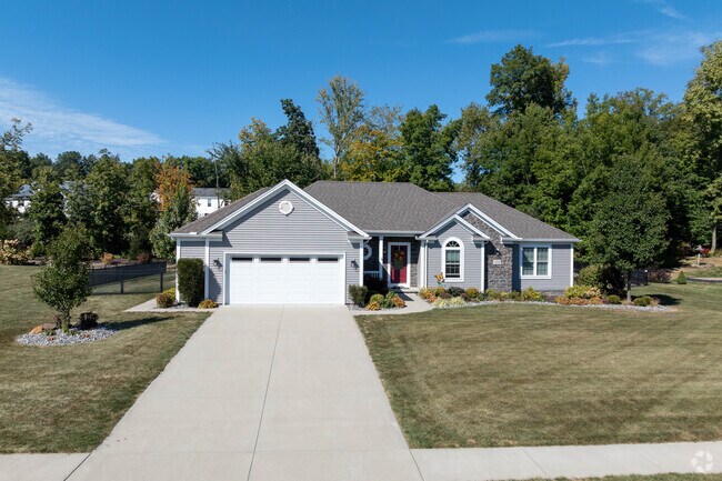 Situated in a new Garretsville development, this modern ranch-style home features a well-manicured lot.