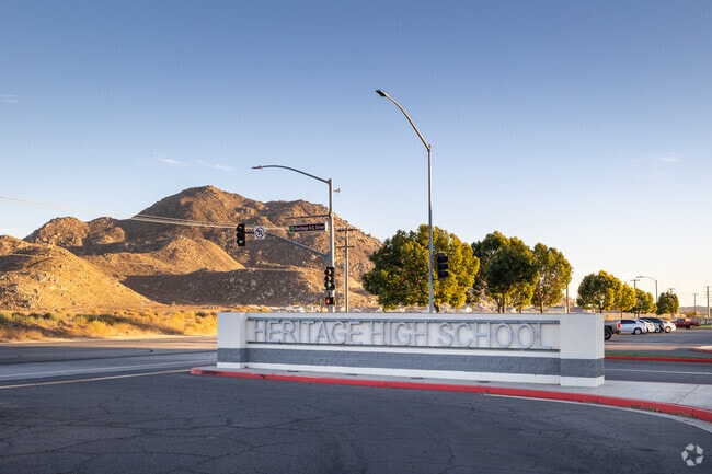 The hills glow as the sunset goes down near Heritage High School in Menifee.