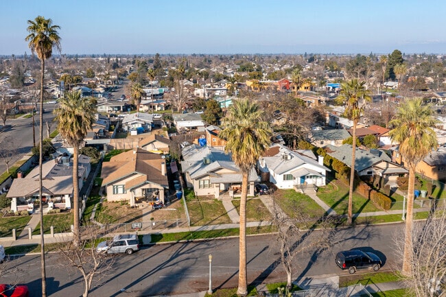 Tall palm trees line the streets in front of Bungalow homes in Fresno's Huntington area.