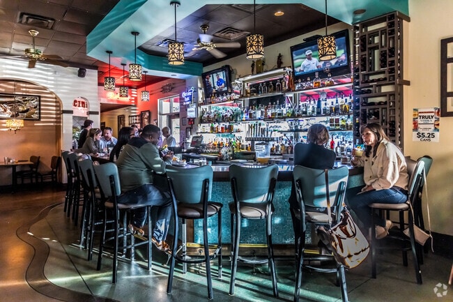 Enjoy a refreshing drink with friends after a long day at the bar at El Porton.