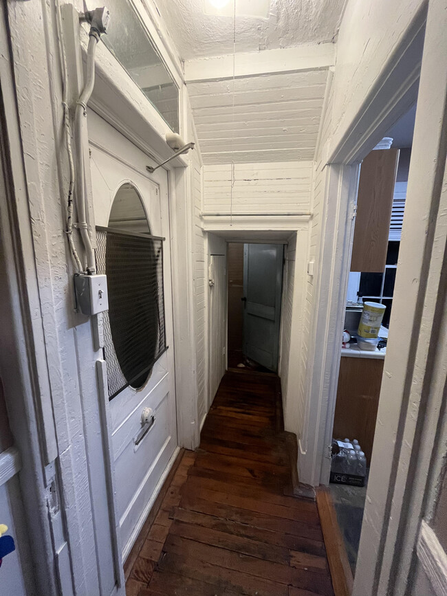 Occupied Hall - front door on left, laundry at the end, kitchen on right