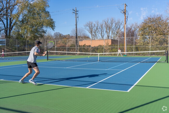 People playing tennis at Weber Park.