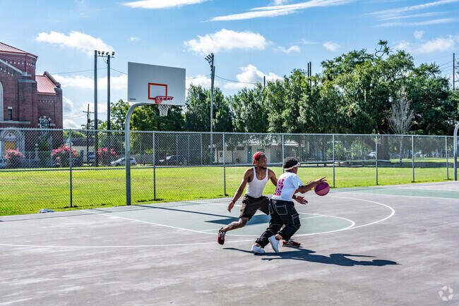 Play a game of pick up basketball on the courts at the Sant Roch Park.