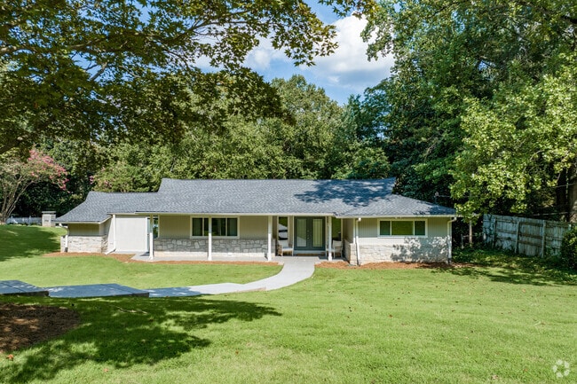 Ranch style homes sit back on lots with mature shade trees.