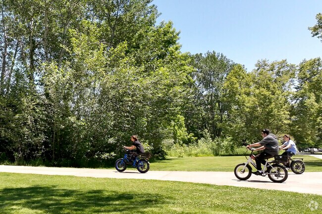 Residents ride down the Boise Greenbelt near Ann Morrison Park.